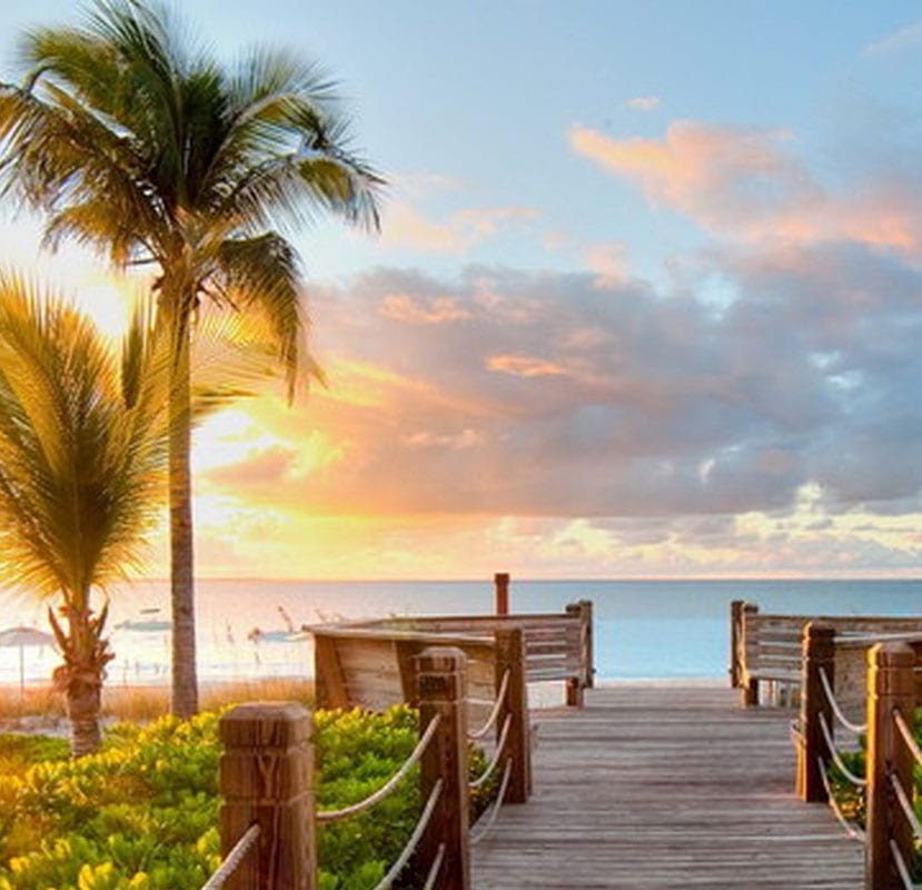 A dock on the ocean at sunset